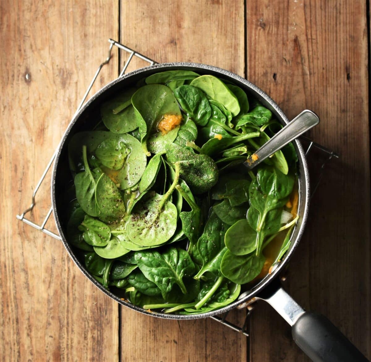 Spinach in pot with spoon.