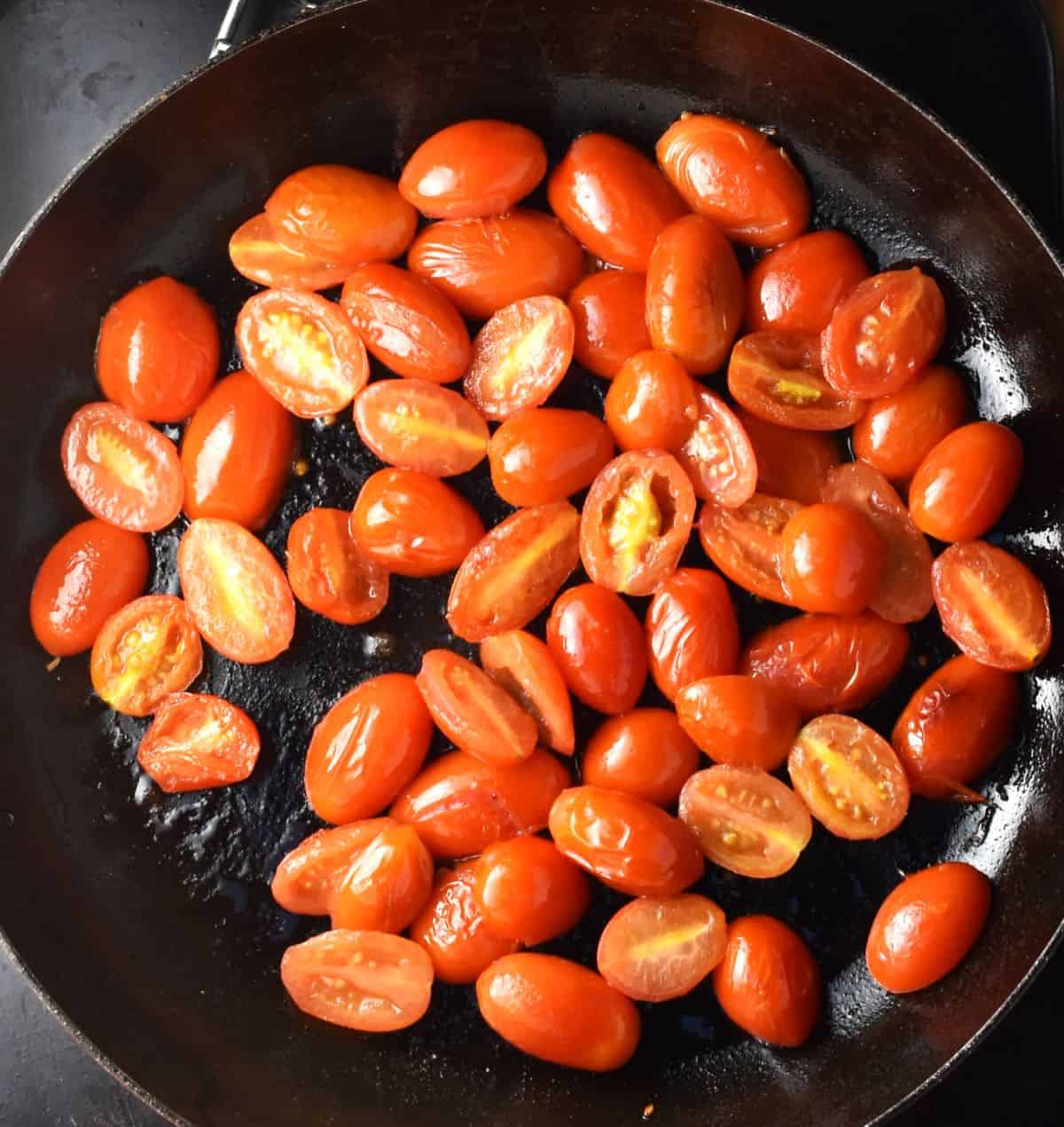 Mini tomato halves in large pan. 