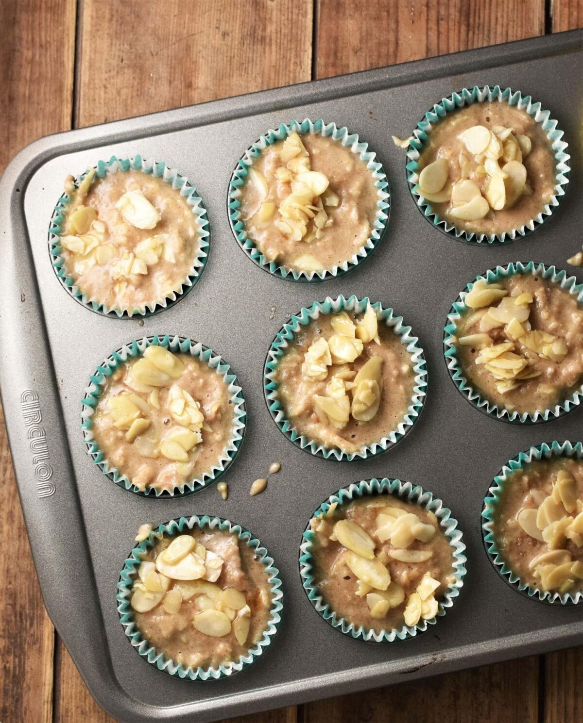 Apple muffin batter in muffin pan.