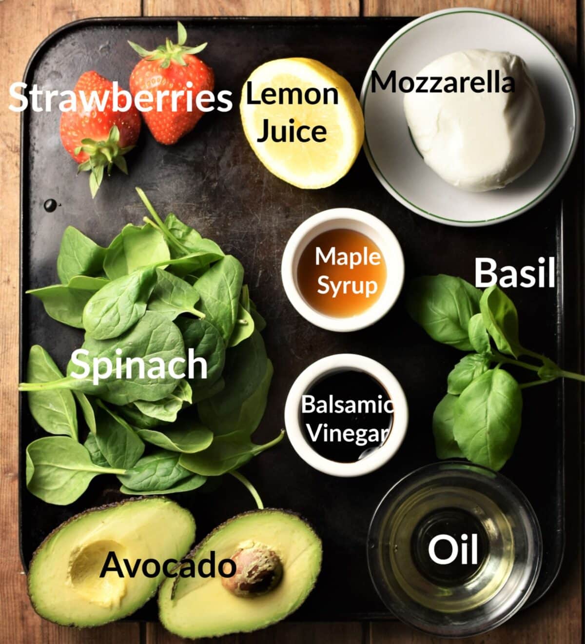 Strawberry and spinach salad ingredients in individual dishes.
