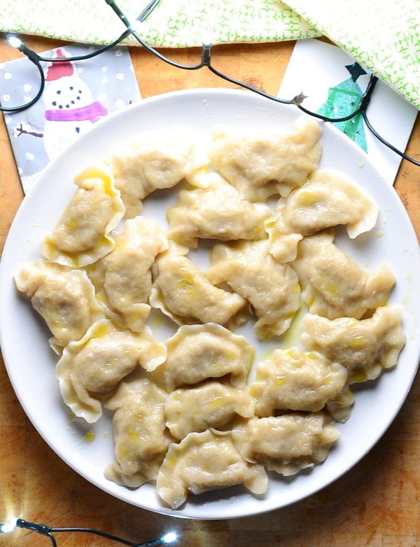 Sauerkraut dumplings on top of white plate.