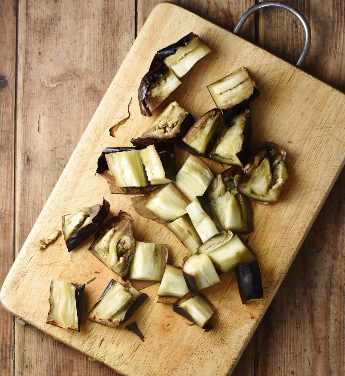 Chopped eggplant on top of cutting board.