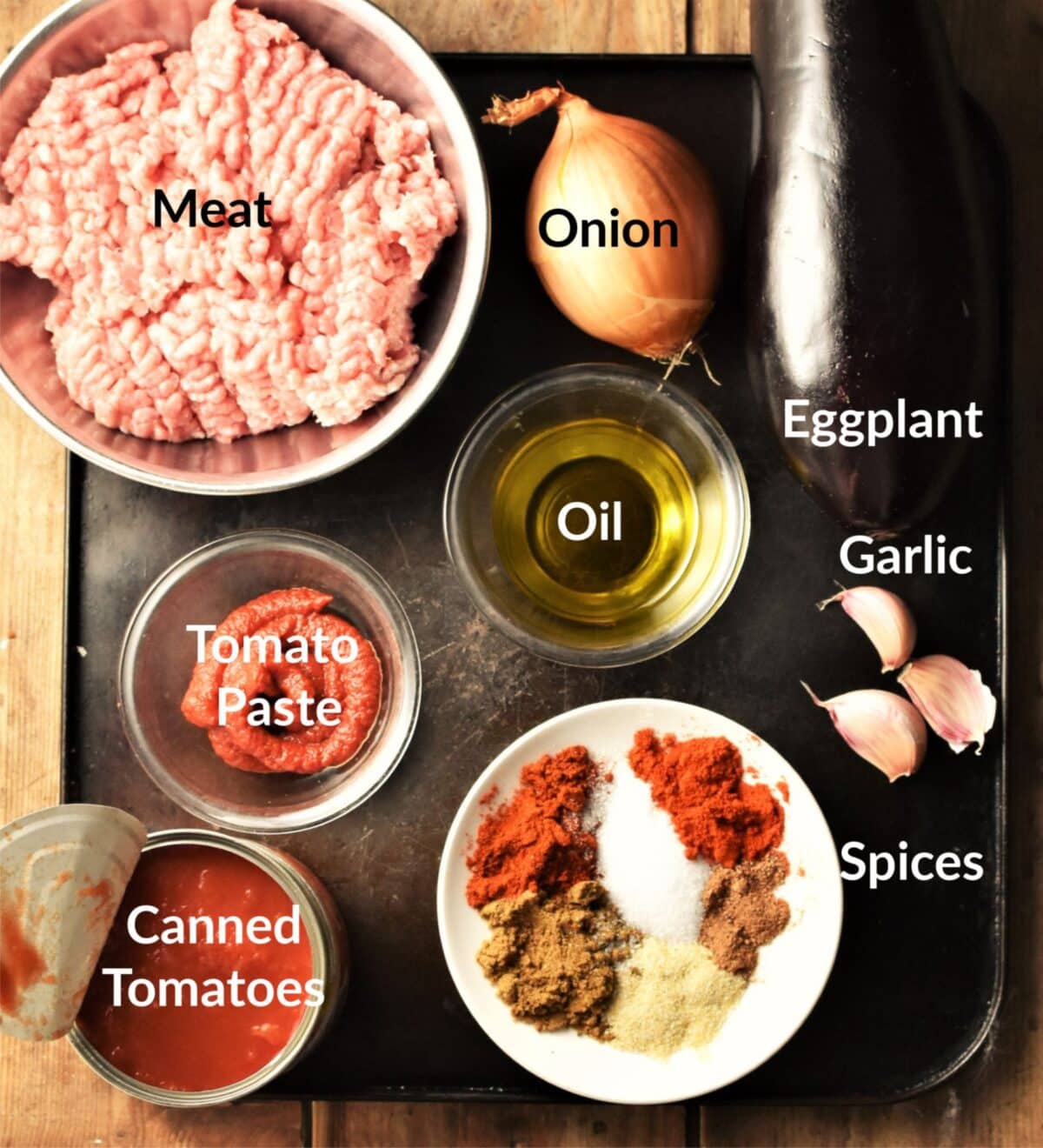 Meat stuffed eggplant ingredients in individual dishes.