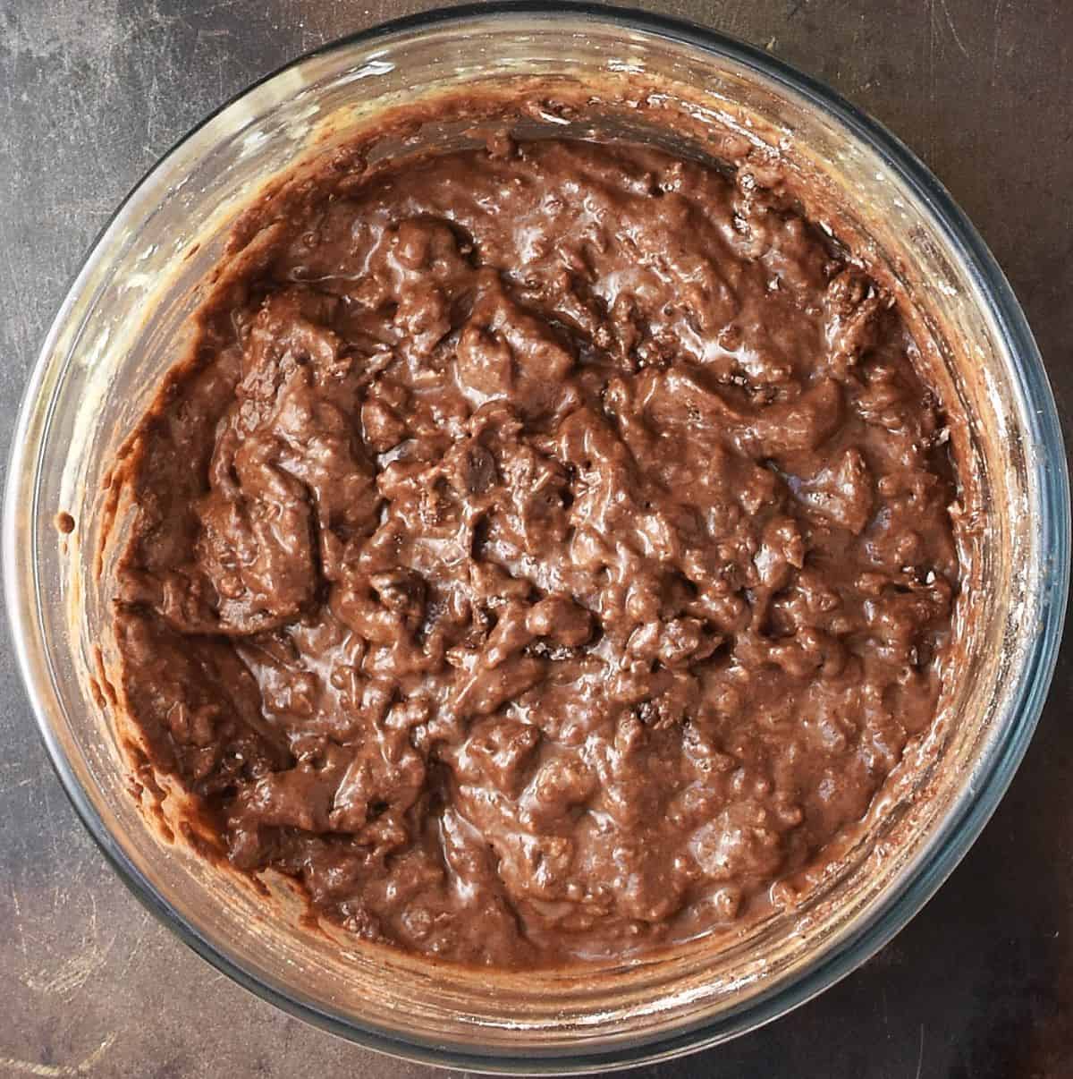 Chocolate coconut muffin batter in large glass bowl.