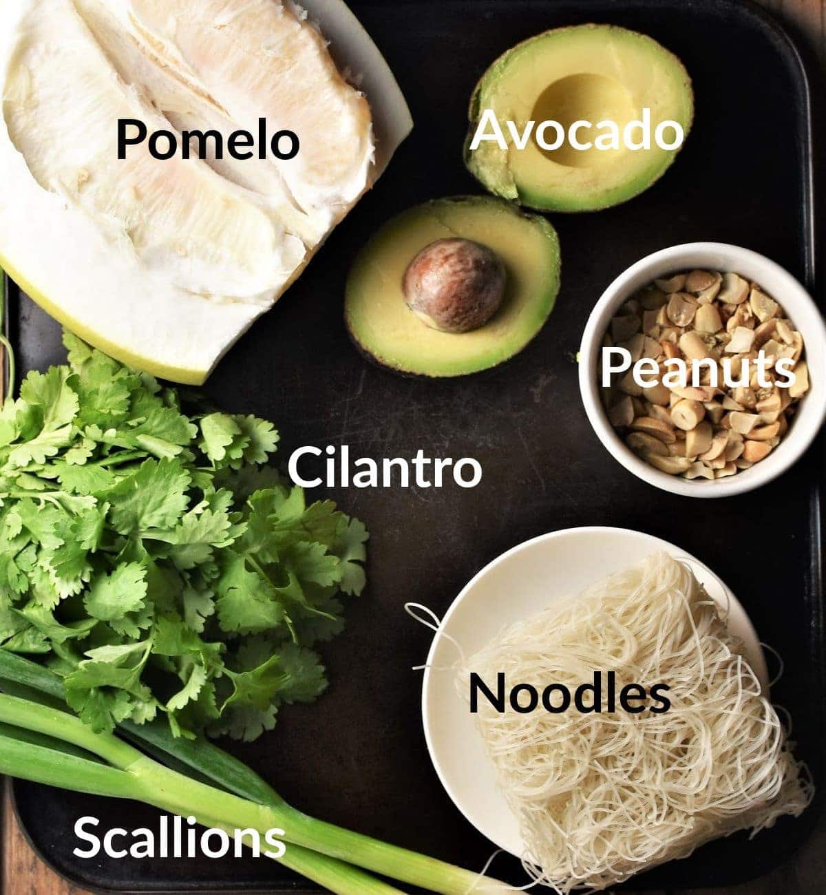 Pomelo salad ingredients in individual dishes.