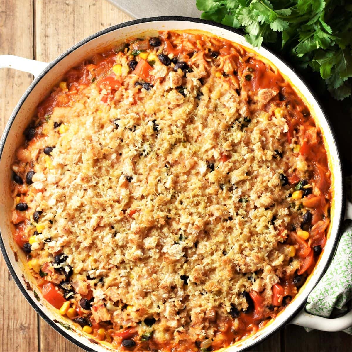Leftover turkey rice casserole with crispy bread topping in large shallow pan.