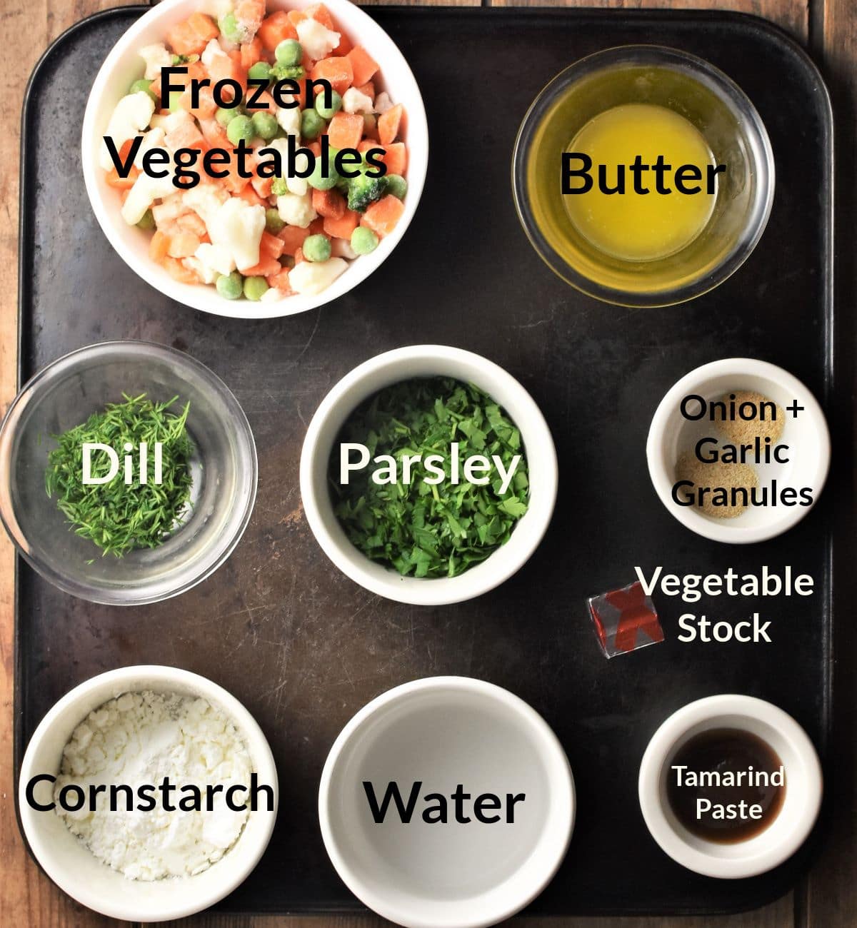 Ingredients for making chunky vegetable soup in individual dishes.