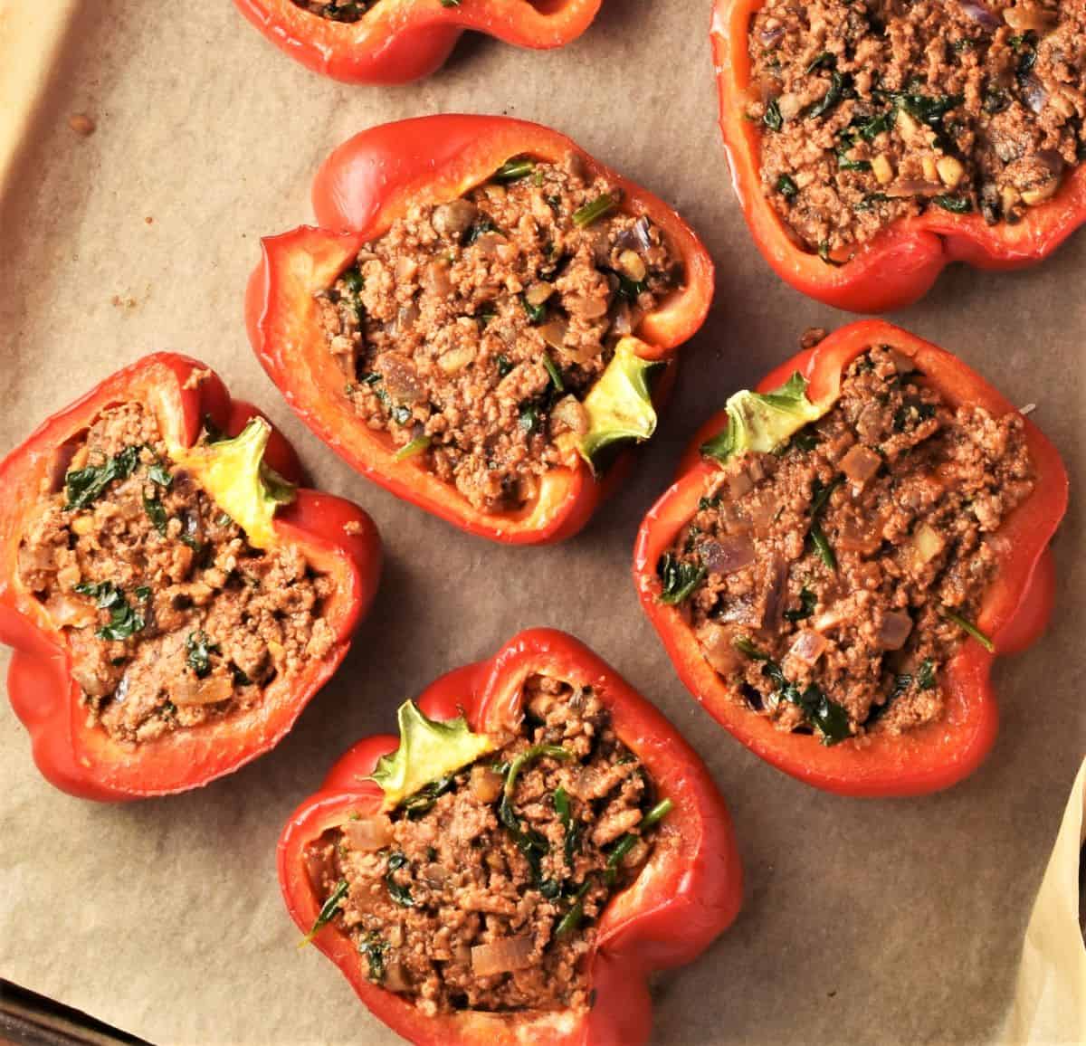 Meat stuffed peppers no-rice on top of parchment.