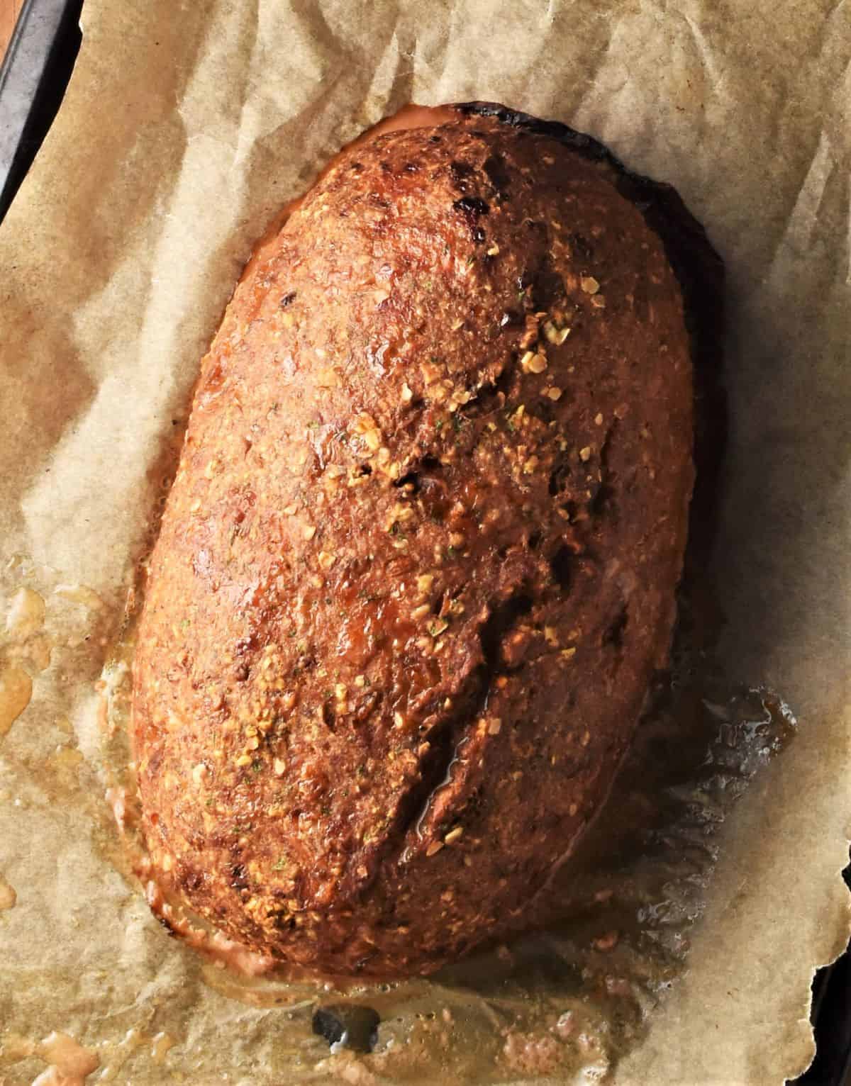 Baked meatloaf on top of parchment.