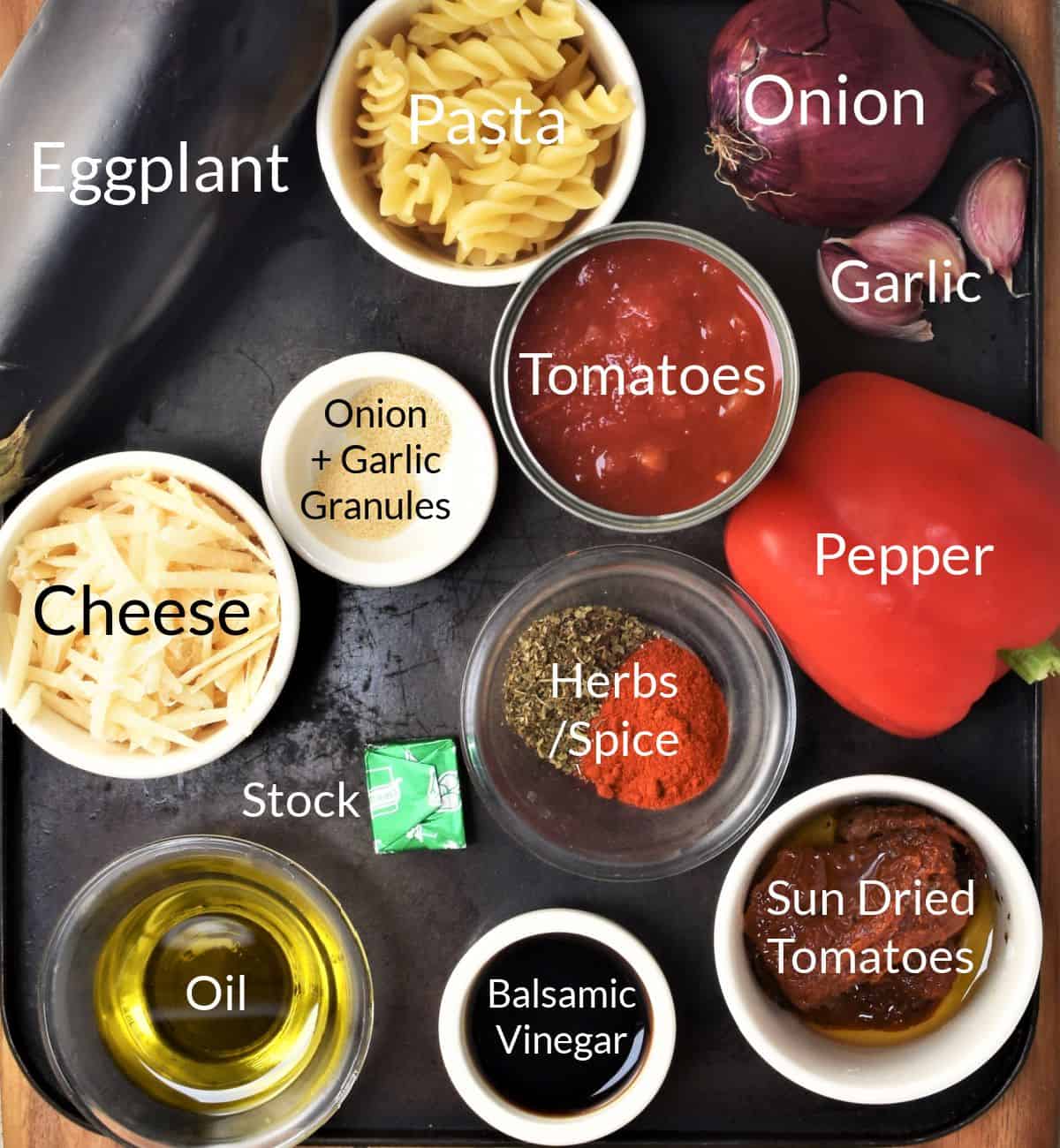 Ingredients for making eggplant pasta bake in individual dishes.