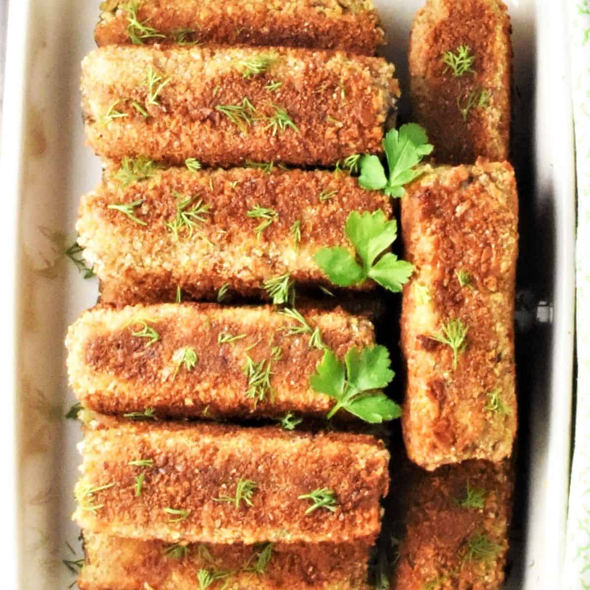Top down view of mushroom croquettes in ceramic dish.